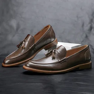 Detailed shot of dark brown leather tassel loafers with wood texture sole