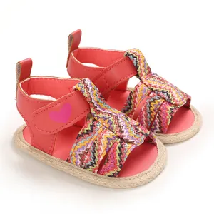 Detailed view of baby girl summer sandals with soft soles and colorful woven straps