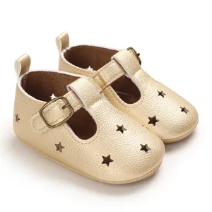 Macro detailed view of gold PU leather baby pre-walker shoes with star cutouts design