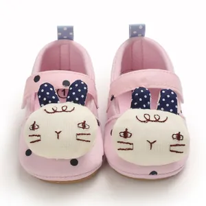 Detail of pink breathable baby walking shoes with cute cartoon rabbit face design