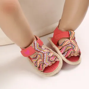 Close-up detail of soft sole baby sandals with colorful chevron pattern for summer
