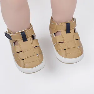 Tan faux leather baby sandals with woven straps and soft white soles for summer walking