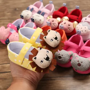 Close-up detail of yellow baby walker shoes with a cute 3D cartoon lion decoration