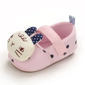 Soft sole pink baby walking shoe with cute cartoon rabbit detail and polka dots
