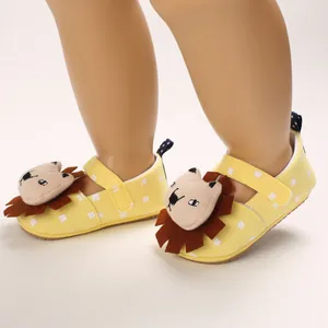 Close-up of yellow baby walker shoes with cute 3D lion design