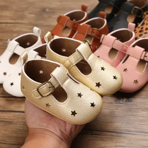Close-up of stylish baby T-strap sandals featuring hollow star patterns in multiple colors.