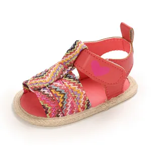Detailed view of soft sole baby summer sandals with colorful woven pattern and pink heart detail