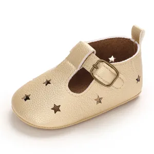 Detailed view of champagne gold baby walker shoe with star cutouts and buckle