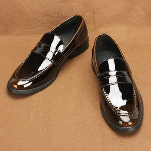 Close-up detail of dark brown patent leather penny loafers featuring a glossy finish