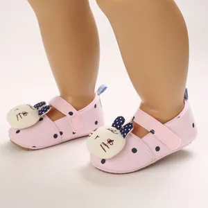 Detailed view of pink polka dot baby walker shoes with cartoon bunny decoration