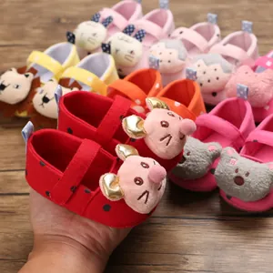 Close-up of soft-soled baby walking shoes with various cute cartoon animal designs.