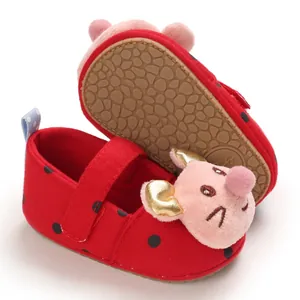 Detailed view of red polka dot infant shoes with soft sole and cartoon mouse design