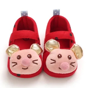 Close-up of red baby walking shoes with cute plush cartoon faces and golden ears