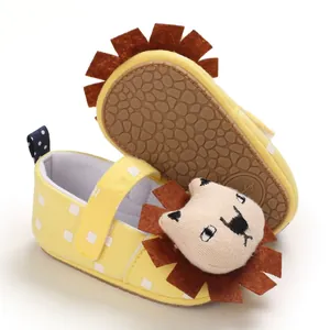 Detailed view of yellow cartoon lion baby walking shoes with soft soles