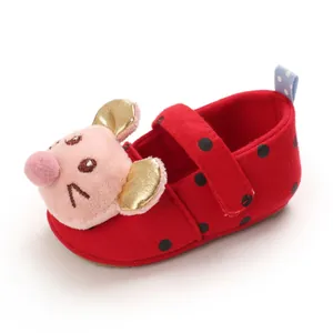 Detailed side view of red baby walking shoes with polka dots and cartoon mouse