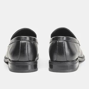 Detailed rear view of classic black men's leather loafers featuring fine heel stitching