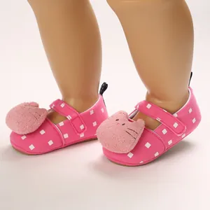 Detailed view of pink soft-soled baby walker shoes with plush cartoon cat and square pattern