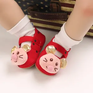 Close-up of cute red baby walker shoes with soft soles and 3D cartoon mouse design