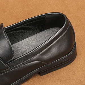 Macro view of black leather business loafer showing premium stitching and heel texture