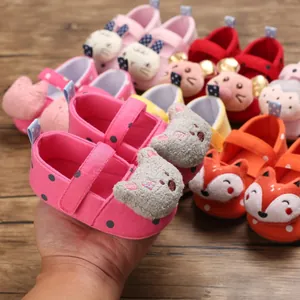 Close-up of pink soft-sole baby shoes with cute 3D bear ears and polka dots pattern