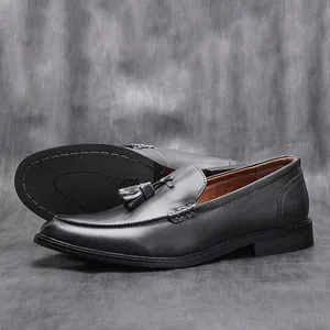 Detailed side profile and sole view of men's dark grey wood grain leather tassel loafers