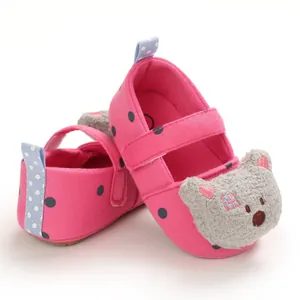 Adorable pink polka dot baby pre-walker shoes with a cute plush bear detail for girls