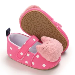 Detailed view of pink baby walking shoe with plush cat head and soft anti-slip sole