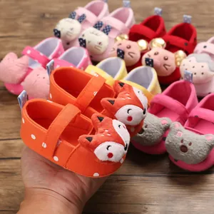 Close-up of an orange soft-sole baby pre-walker shoe with a cute fox character and dots.