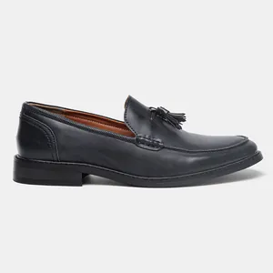 Close-up profile of men's black leather tassel loafers with elegant apron stitching