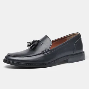 Elegant men's navy blue leather tassel loafer shoes with wood grain detail on the sole