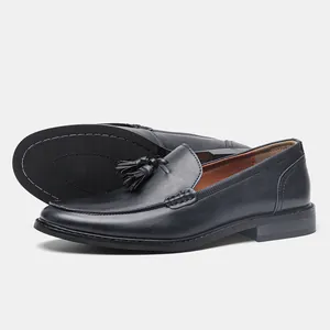 Detail of black leather tassel loafers showing the non-slip sole and side profile