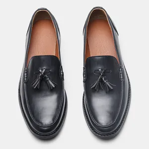 Overhead detail of men's leather business loafers with stylish tassel decoration