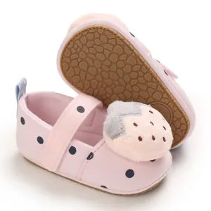 Detail view of pink baby girl walker shoes with strawberry plush and non-slip rubber sole