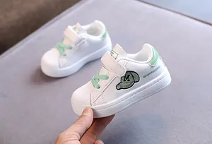 Toddler white shell-toe sneakers with green laces and velcro strap