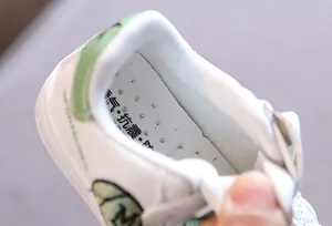 Detailed macro view of the breathable insole inside children's white casual low-top sneaker