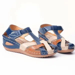 Detail view of retro wedge sandals with colorful crisscross straps and contrast stitching