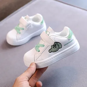 Casual white toddler board shoes with soft soles and green shell toe design details