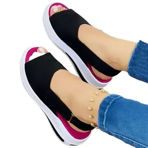 Women's platform peep-toe sandals with black upper, pink lining and velcro back strap.