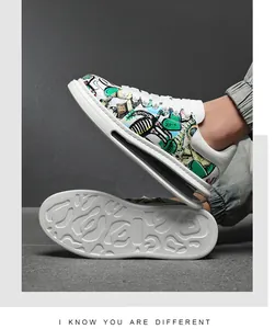 Detail view of men's graffiti print skate shoes with non-slip white rubber sole