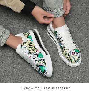 Detail view of men's fashion printed casual sneakers with graffiti heart and card patterns
