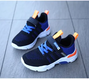 Detailed close-up view of breathable blue and black mesh upper on sporty running shoes for boys