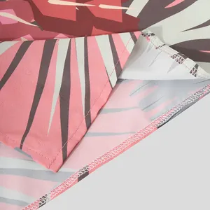Detalle macro de tela con estampado de hojas y costura de dobladillo en camisa hawaiana