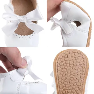 Detailansicht der flexiblen weichen Sohle und des Klettverschlusses weißer Babyschuhe