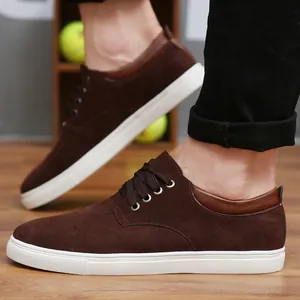 Detailed side view of brown suede men's casual sneakers with a thick white sole