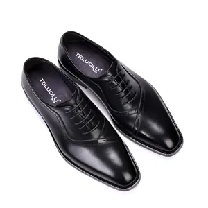Primer plano de zapatos Oxford de cuero negro con detalles brogue clásicos y elegantes