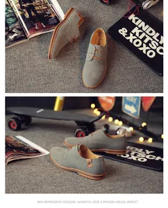 Detailed view of gray suede men's casual shoes with brown trim and laces