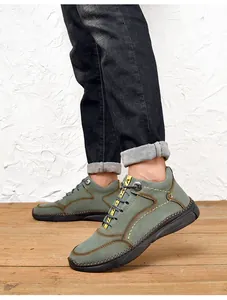 Detailed side view of green suede men's casual shoes with yellow accents and thick sole.