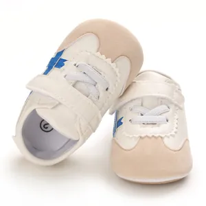 Close-up of white baby walking shoes with blue stripes and soft sole for 0-1 year old.