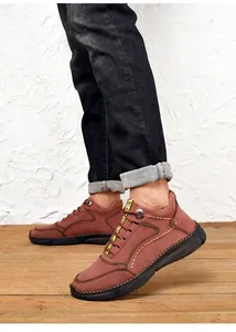Detailed side view of men's reddish-brown leather casual shoes with contrast yellow laces.