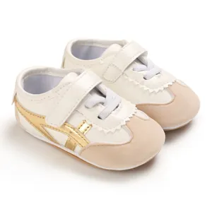 Comfortable soft sole baby walking shoes with white upper and stylish golden stripes
